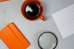 Stylish flat lay of coffee and office supplies on a desk. Ideal for productivity themes.