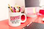 Humorous coffee mug filled with pens on a vibrant office desk, creating a quirky workspace vibe.