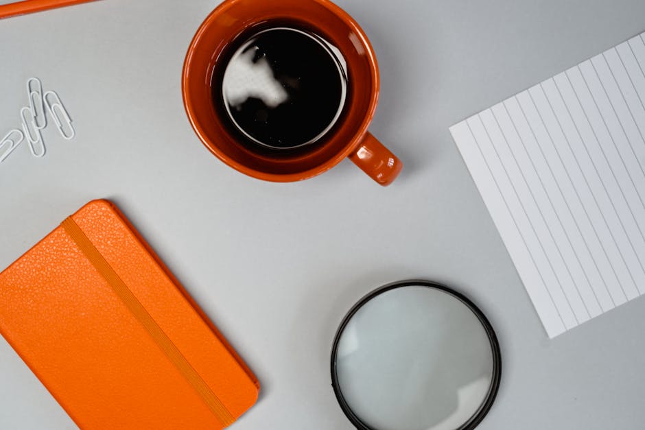 Stylish flat lay of coffee and office supplies on a desk. Ideal for productivity themes.
